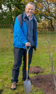 Chris Quine, Chief Scientist at Forest Research and recently awarded Fellow of the Royal Society of Edinburgh, outside holding a spade, preparing to plant a tree 