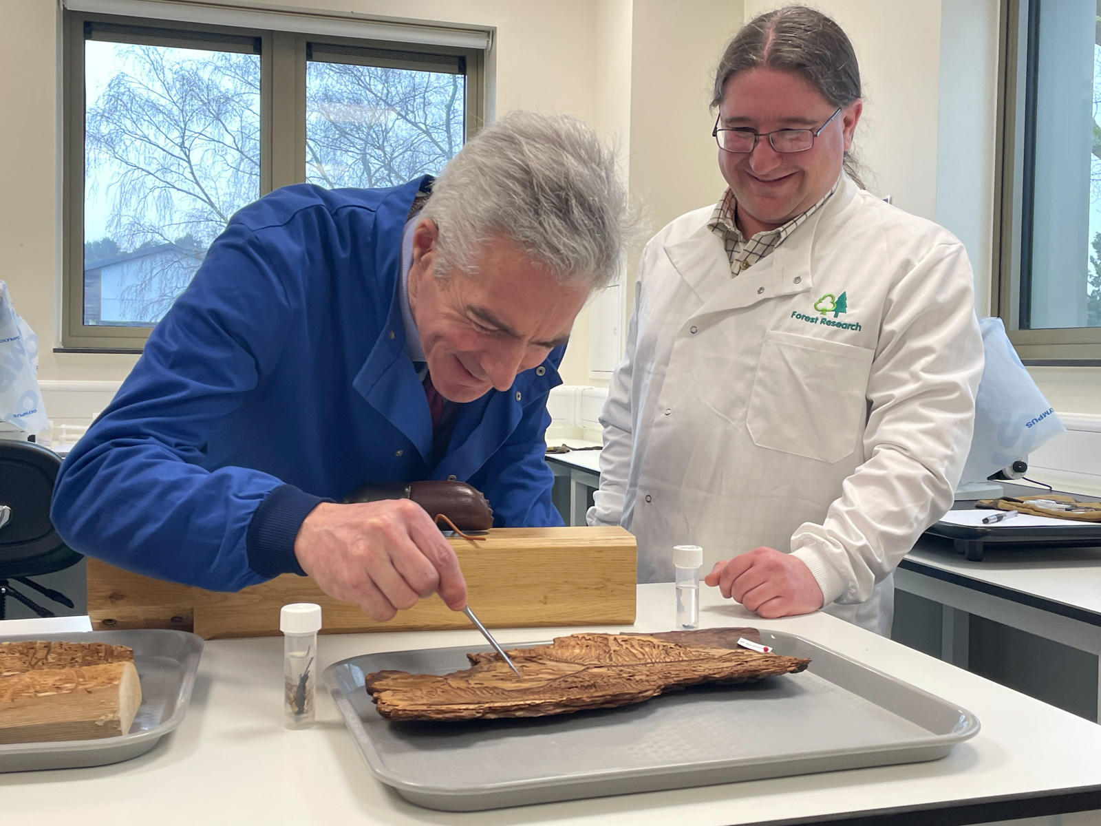 Lord Douglas-Miller OBE, Parliamentary Under-Secretary of State at Defra and Minister for Biosecurity, Animal Health and Welfare, takes a closer inspection at a piece of bark. 