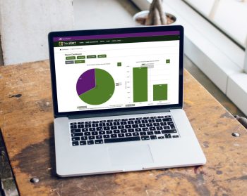 A laptop on a table displays the new dashboard on the TreeAlert site.