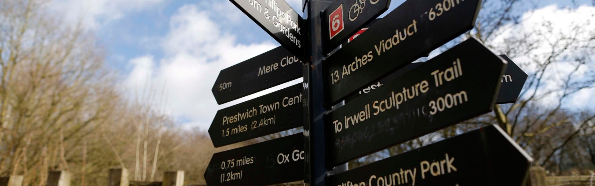 A signpost for public access in woodland.