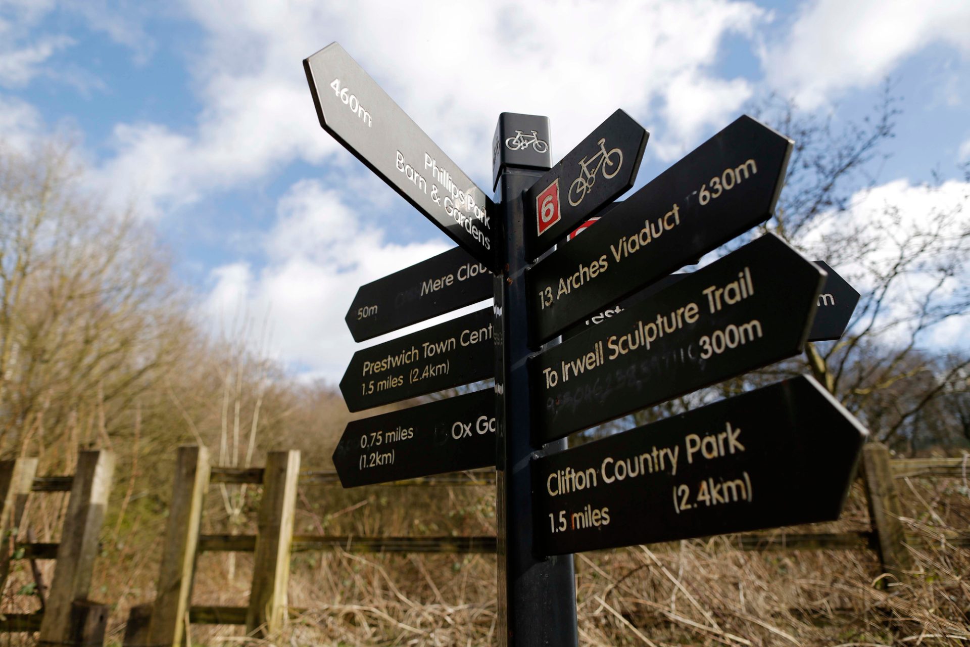 A signpost for public access in woodland.