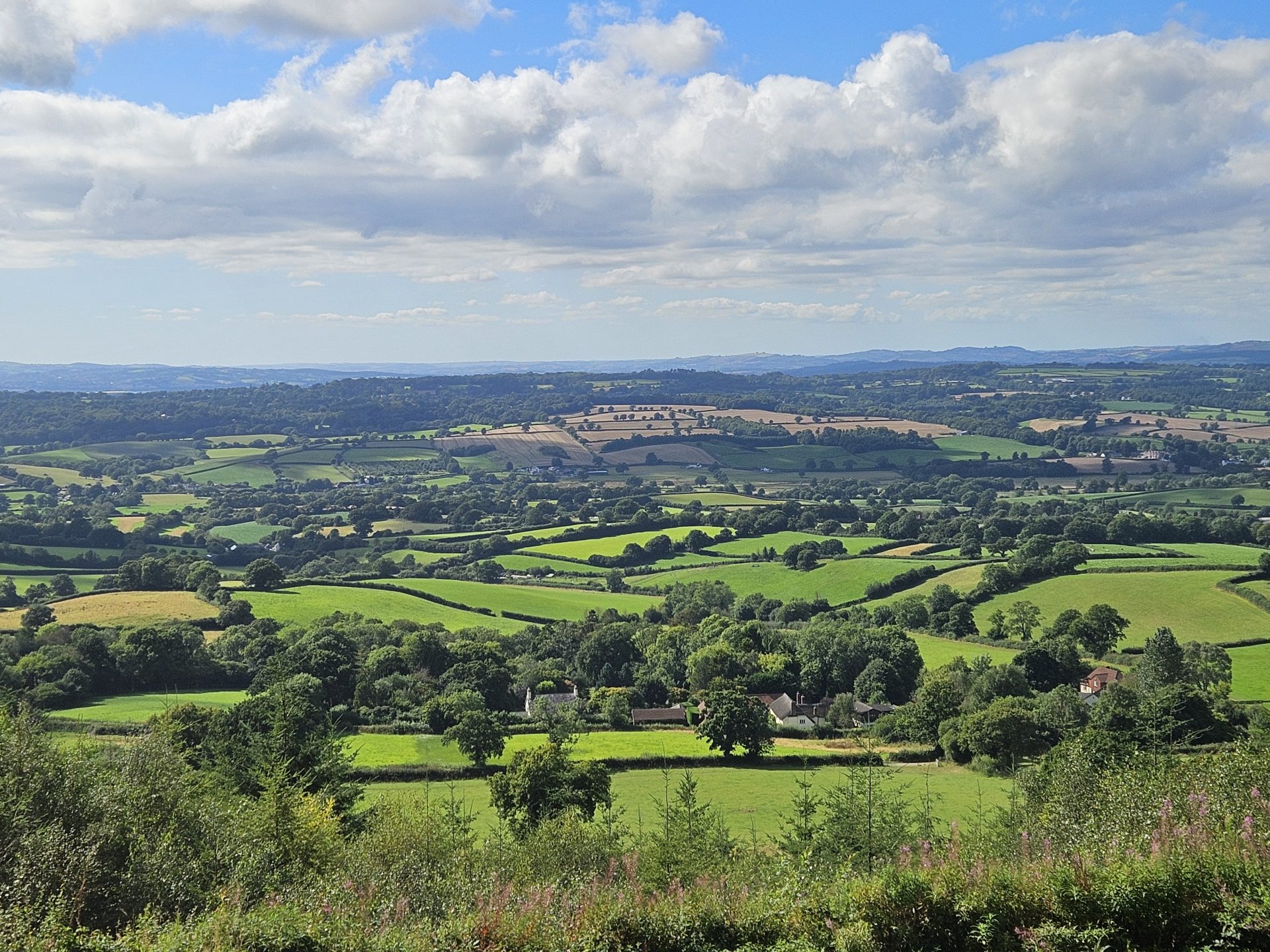 An image of the Otter Valley landscape in Devon, England taken from atop a hill.