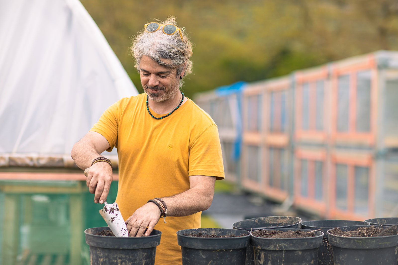 Person using trowel while potting trees