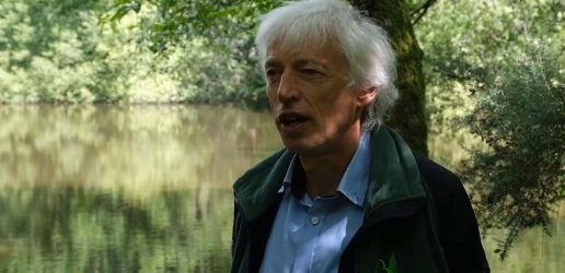 A photograph of Tom Nisbet with riparian woodland in the background.