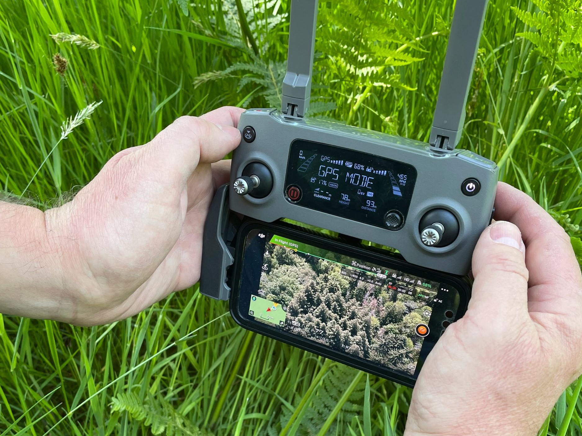 A photograph of the controls of a drone mapping woodland. 