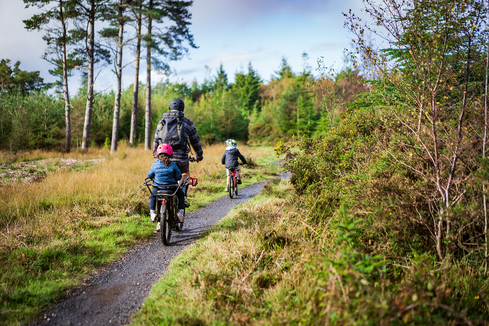 Family cycling in woods