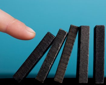 Finger setting off domino effect.
