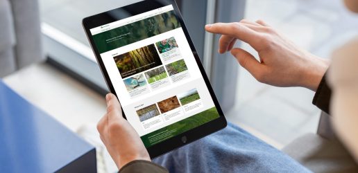 A person using a tablet to explore the Forest Research Climate Change Hub