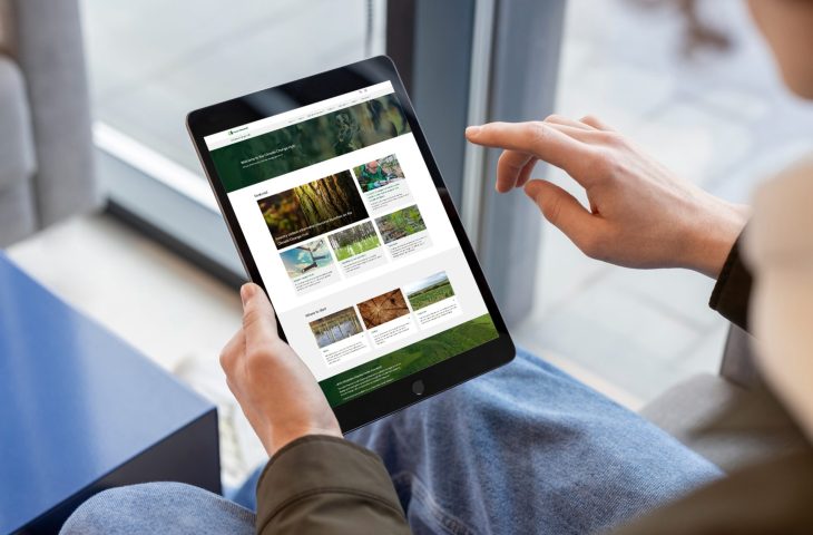 A person using a tablet to explore the Forest Research Climate Change Hub