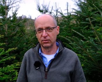 A photo of David Edwards in front of trees.