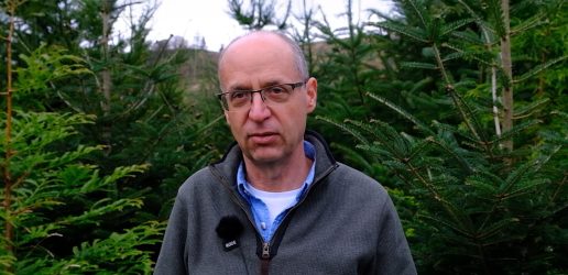 A photo of David Edwards in front of trees.