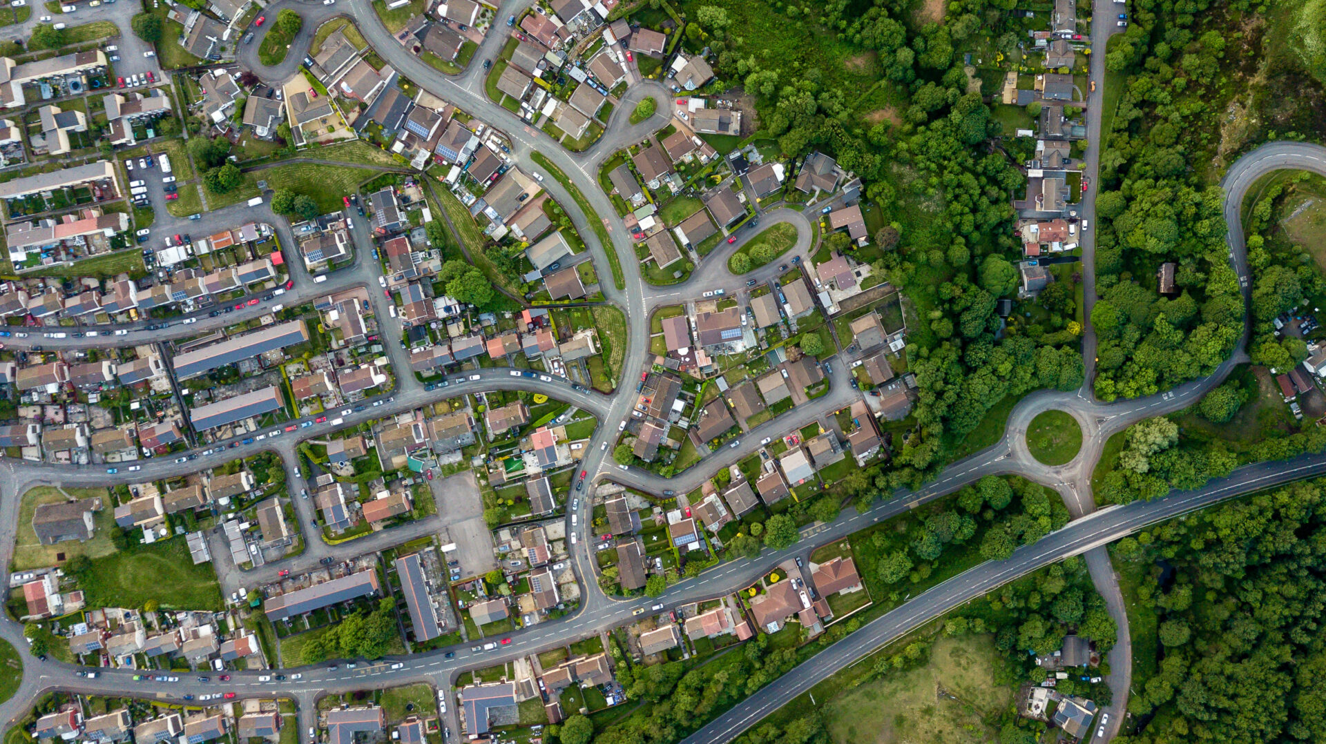 Top down aerial view of an urban area in a small town surrounded