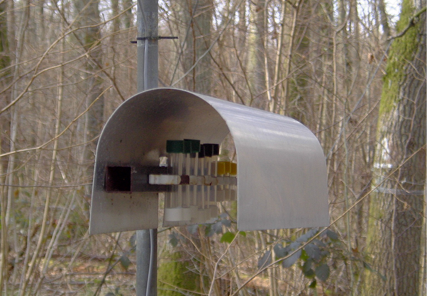Image of multiple diffusion tubes used to monitor air quality under a metal cover